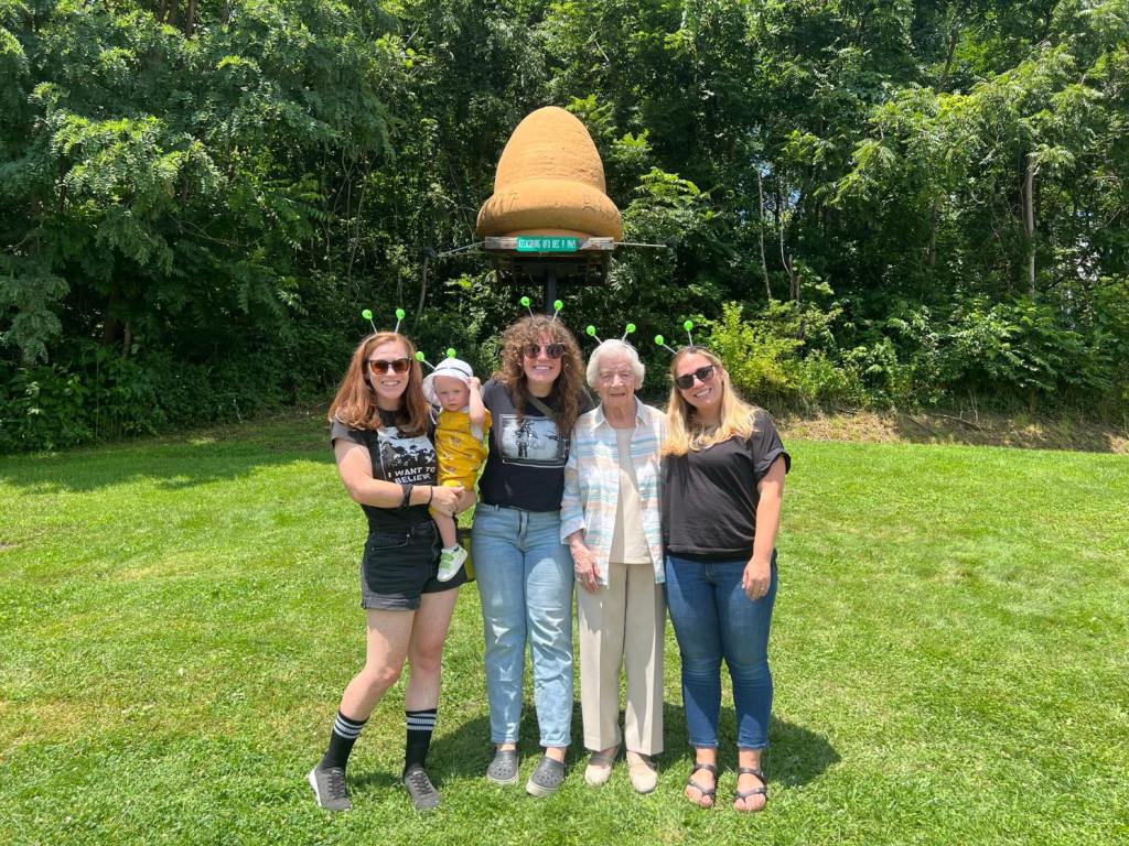 Kristen, with her daughter Trudy, sisters Courtney and Jess, and grandmother Rose in front of the alien spaceship landing spot.