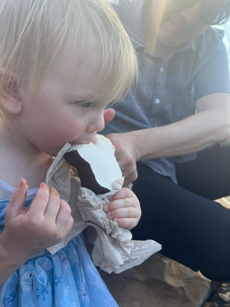 toddler eats a Mickey Bar ice cream bar