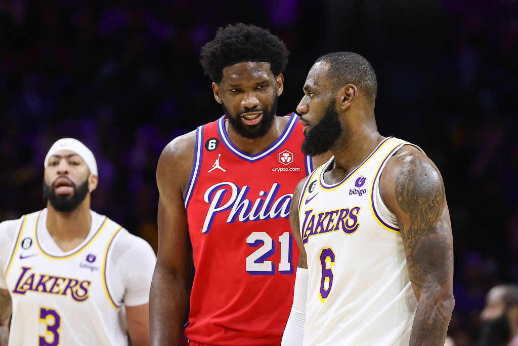 PHILADELPHIA, PENNSYLVANIA - DECEMBER 09: Joel Embiid #21 of the Philadelphia 76ers and LeBron James #6 of the Los Angeles Lakers speak during the fourth quarter at Wells Fargo Center on December 09, 2022 in Philadelphia, Pennsylvania.