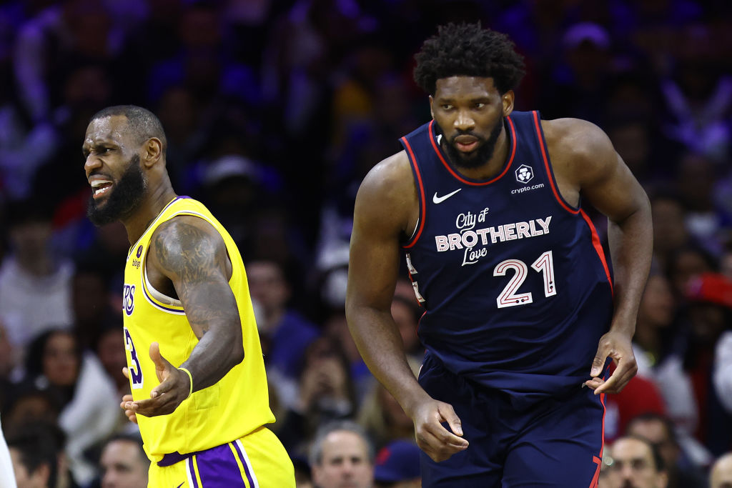 PHILADELPHIA, PENNSYLVANIA - NOVEMBER 27: LeBron James #23 of the Los Angeles Lakers reacts behind Joel Embiid #21 of the Philadelphia 76ers during the third quarter at the Wells Fargo Center on November 27, 2023 in Philadelphia, Pennsylvania.