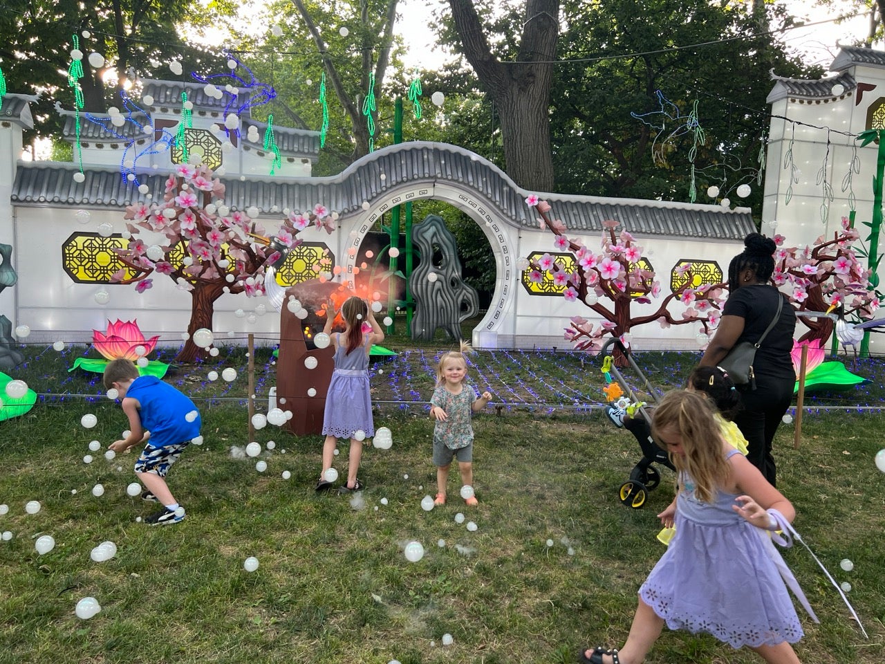 Smoke filled bubbles were a highlight again this year. The photo shows a daytime shot of a group of kids playing in the bubbles in front of one of the festival lantern scenes.