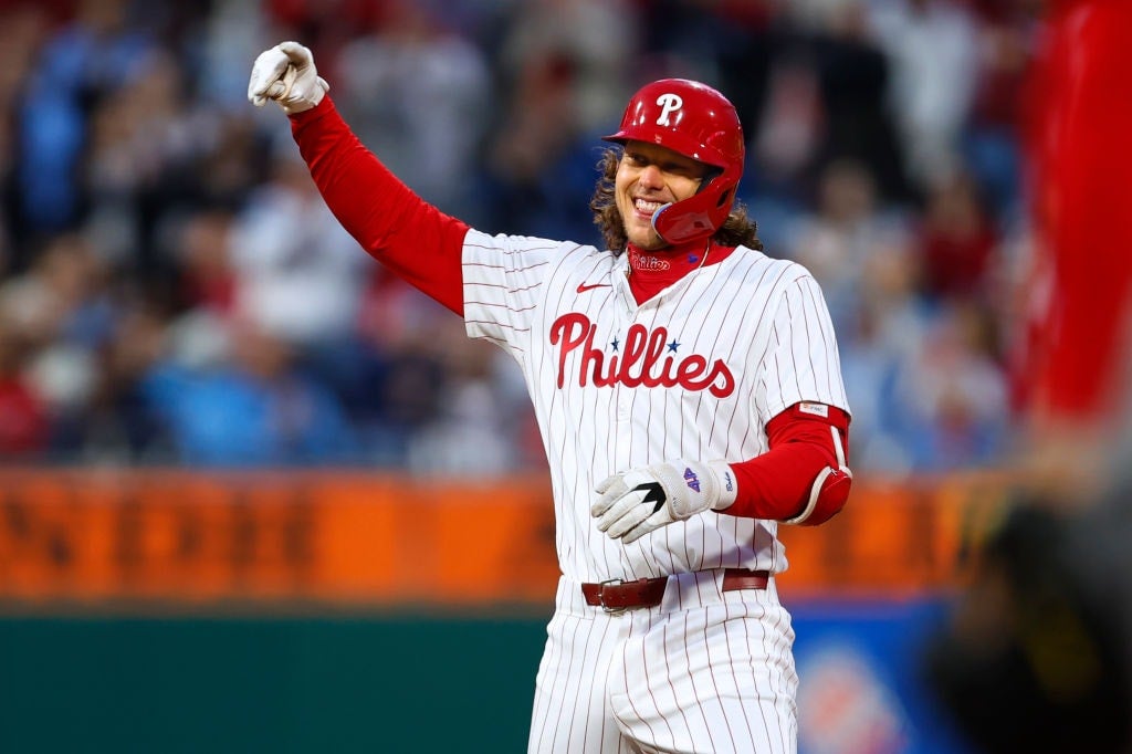 Alec Bohm #28 of the Philadelphia Phillies gestures after he hit a two-run double against the Cincinnati Reds